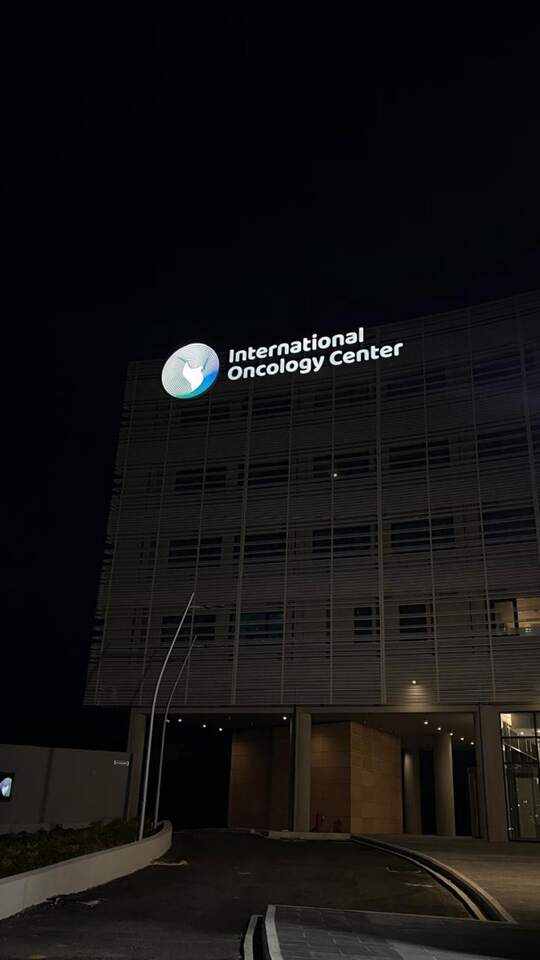 The same sign at night, International Oncology Center